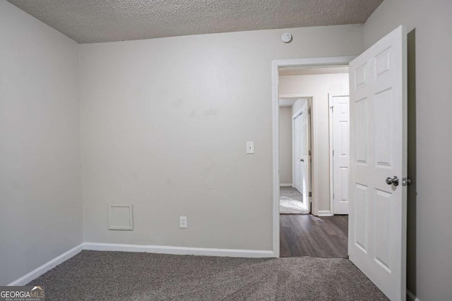 2800 Macon Dr SE, Atlanta, GA 30354 - spare room featuring dark colored carpet, baseboards, a textured ceiling, and a smoke detector