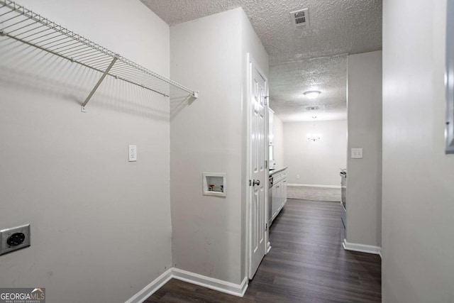 2800 Macon Dr SE, Atlanta, GA 30354 - washroom with hookup for an electric dryer, hookup for a washing machine, a textured ceiling, baseboards, and dark wood-type flooring