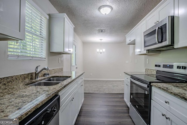 2800 Macon Dr SE, Atlanta, GA 30354 - kitchen featuring stainless steel appliances, a sink, a textured ceiling, white cabinetry, and a chandelier