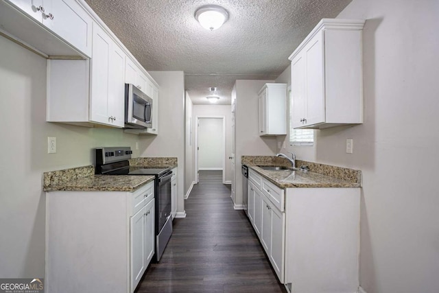 2800 Macon Dr SE, Atlanta, GA 30354 - kitchen with appliances with stainless steel finishes, a sink, a textured ceiling, dark wood finished floors, and white cabinets