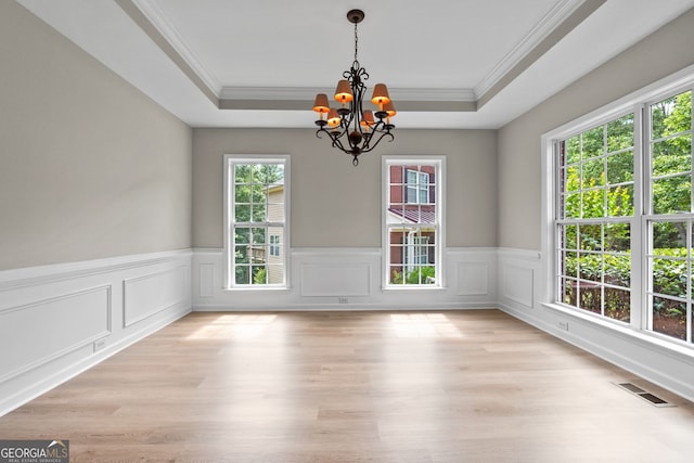 1429 Kentmire Ct, Locust Grove, GA 30248 - unfurnished dining area with a chandelier, wainscoting, ornamental molding, a tray ceiling, and light wood-style floors