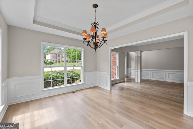 1429 Kentmire Ct, Locust Grove, GA 30248 - unfurnished dining area with ornamental molding, decorative columns, a decorative wall, a chandelier, and a wainscoted wall