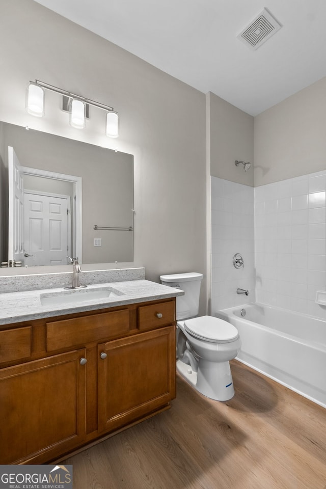 1429 Kentmire Ct, Locust Grove, GA 30248 - full bath with wood finished floors, vanity, toilet, and shower / washtub combination