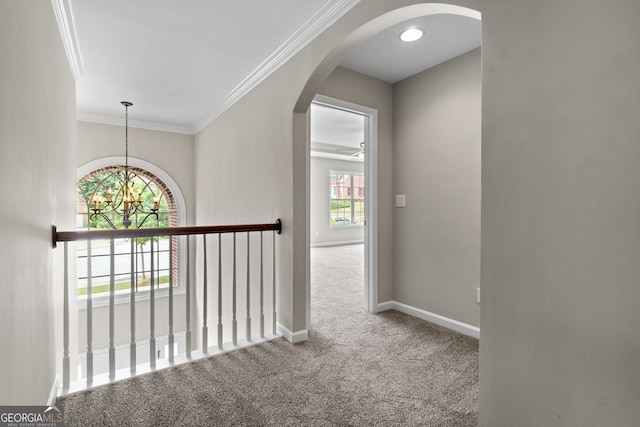 1429 Kentmire Ct, Locust Grove, GA 30248 - hallway with arched walkways, carpet, a chandelier, crown molding, and baseboards