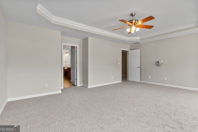 1429 Kentmire Ct, Locust Grove, GA 30248 - unfurnished bedroom with a tray ceiling, crown molding, light carpet, baseboards, and ensuite bath