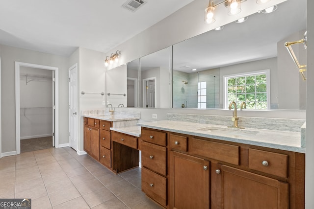 1429 Kentmire Ct, Locust Grove, GA 30248 - full bathroom with a shower stall, tile patterned floors, baseboards, double vanity, and a spacious closet