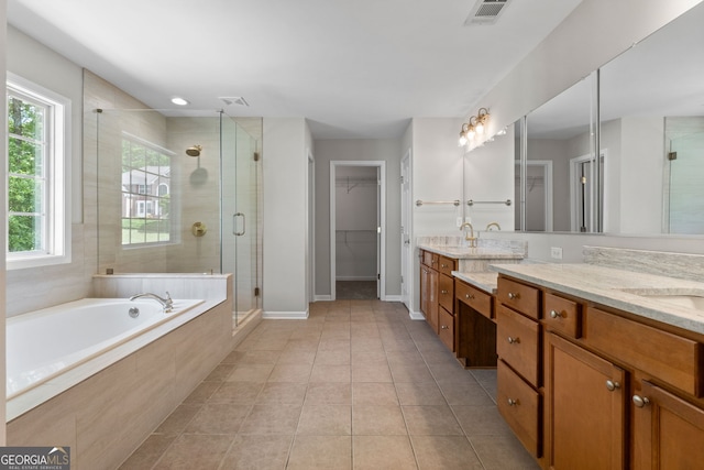 1429 Kentmire Ct, Locust Grove, GA 30248 - bathroom featuring a stall shower, double vanity, a bath, and a walk in closet