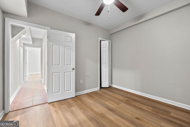 1429 Kentmire Ct, Locust Grove, GA 30248 - unfurnished bedroom featuring baseboards, light wood-type flooring, a closet, and ceiling fan