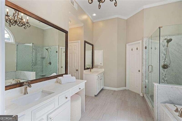 full bath featuring a chandelier, crown molding, a shower stall, a garden tub, and two vanities