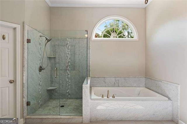 full bathroom with a shower stall, a garden tub, and crown molding