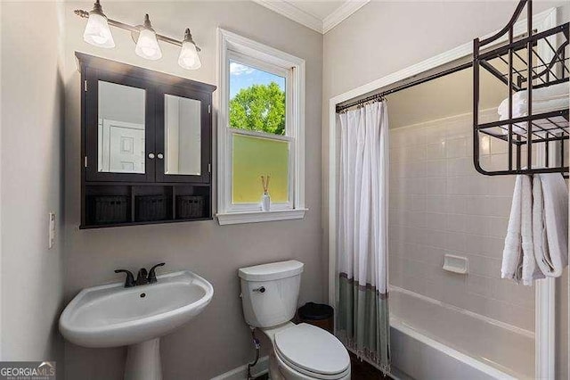 full bathroom featuring toilet, crown molding, a sink, and shower / tub combo