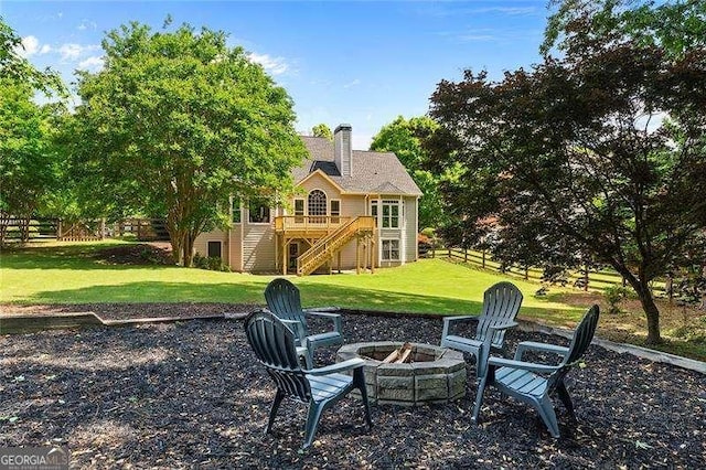 view of yard with a fire pit, stairs, and a wooden deck