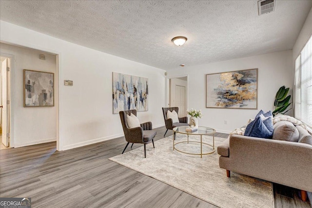 203 Brannan Rd, Mcdonough, GA 30253 - living room featuring wood finished floors, baseboards, and a textured ceiling