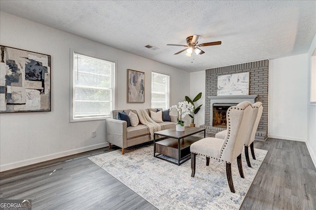 203 Brannan Rd, Mcdonough, GA 30253 - living area with a ceiling fan, wood finished floors, a textured ceiling, and baseboards