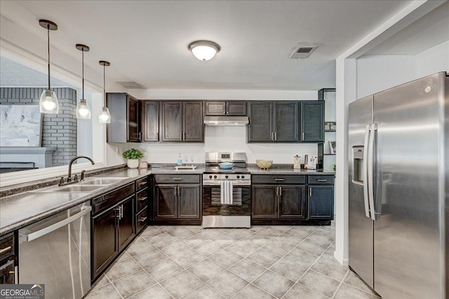 203 Brannan Rd, Mcdonough, GA 30253 - kitchen featuring stainless steel appliances, a sink, under cabinet range hood, dark brown cabinetry, and hanging light fixtures