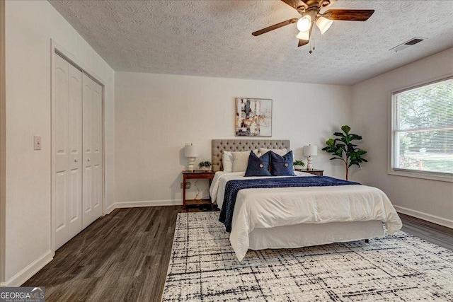 203 Brannan Rd, Mcdonough, GA 30253 - bedroom featuring wood finished floors, a textured ceiling, baseboards, ceiling fan, and a closet