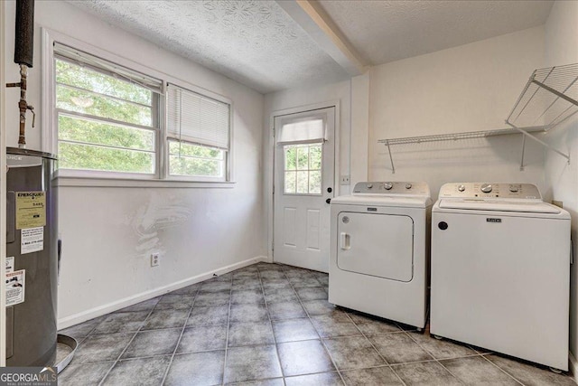 203 Brannan Rd, Mcdonough, GA 30253 - laundry room with water heater, washer and clothes dryer, a textured ceiling, and baseboards