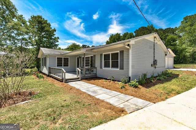203 Brannan Rd, Mcdonough, GA 30253 - ranch-style home with a porch, a front yard, and a garage