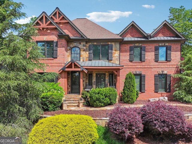 3282 Green Farm Trl, Dacula, GA 30019 - craftsman inspired home featuring a standing seam roof, brick siding, and metal roof