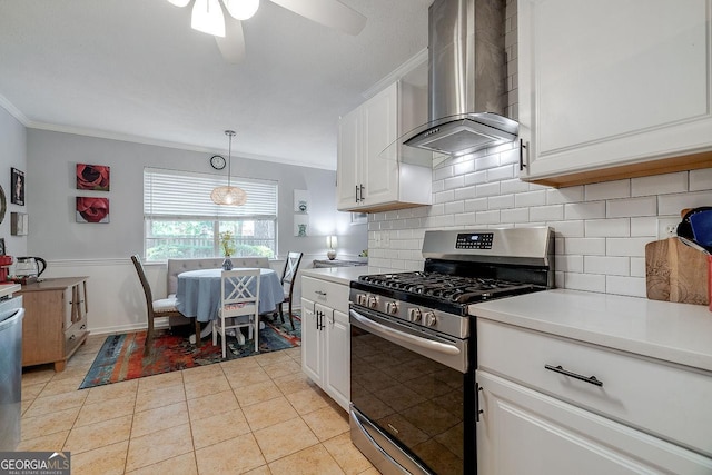kitchen featuring stainless steel gas range oven, exhaust hood, crown molding, decorative backsplash, and white cabinets