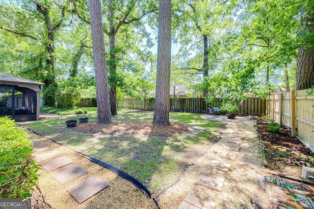 fenced backyard featuring a sunroom