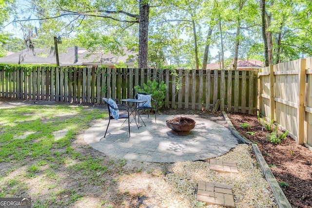 view of patio featuring a fire pit and a fenced backyard