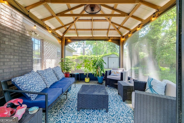 sunroom featuring an outdoor hangout area and vaulted ceiling