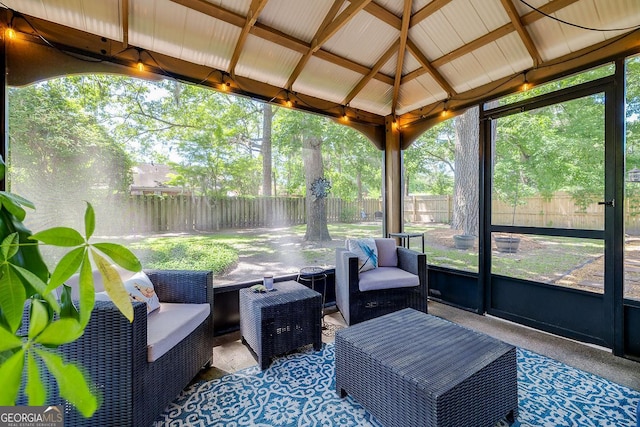 sunroom featuring outdoor lounge area, lofted ceiling, and plenty of natural light