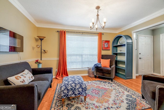 living area with crown molding, a chandelier, and wood finished floors