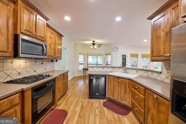 1425 Turtle Dove Ln, Lawrenceville, GA 30043 - kitchen featuring black appliances, backsplash, ceiling fan, brown cabinets, and light wood-style floors