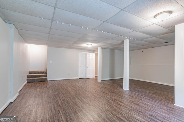 1076 Plantation Blvd SE, Conyers, GA 30094 - basement with a paneled ceiling, wood finished floors, and baseboards