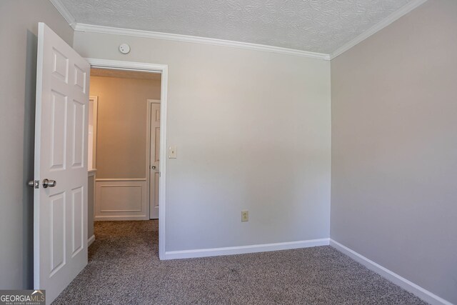 1076 Plantation Blvd SE, Conyers, GA 30094 - carpeted empty room featuring wainscoting, a textured ceiling, and a decorative wall