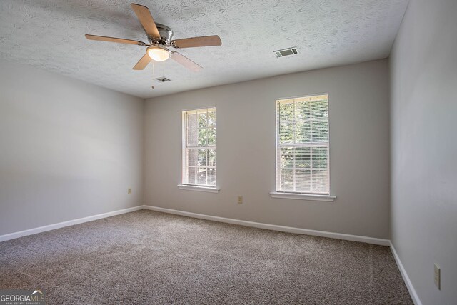 1076 Plantation Blvd SE, Conyers, GA 30094 - unfurnished bedroom with carpet, a textured ceiling, baseboards, and ceiling fan