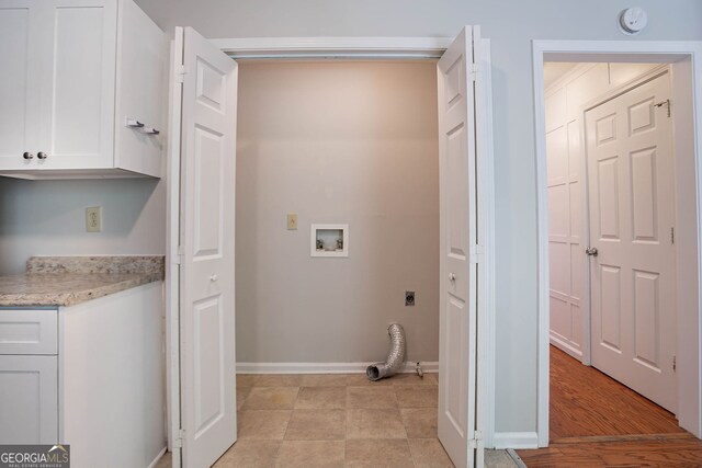 1076 Plantation Blvd SE, Conyers, GA 30094 - kitchen with freestanding refrigerator, white cabinets, a textured ceiling, a decorative wall, and wainscoting
