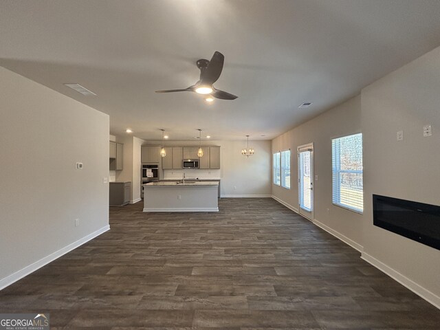 5314 Tolar Rd Unit 23, South Fulton, GA 30213 - unfurnished living room with a ceiling fan, baseboards, dark wood finished floors, a chandelier, and recessed lighting
