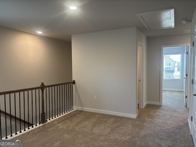 hallway featuring attic access, carpet, baseboards, and recessed lighting
