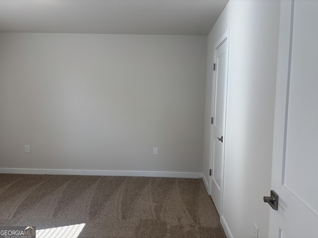 carpeted empty room with baseboards