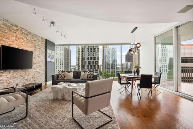 20 10th St NW Unit 2003, Atlanta, GA 30309 - living area with a wall of windows, a view of city, wood finished floors, a chandelier, and rail lighting