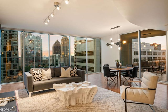 20 10th St NW Unit 2003, Atlanta, GA 30309 - living room with a wall of windows, wood finished floors, a chandelier, and a skyline view