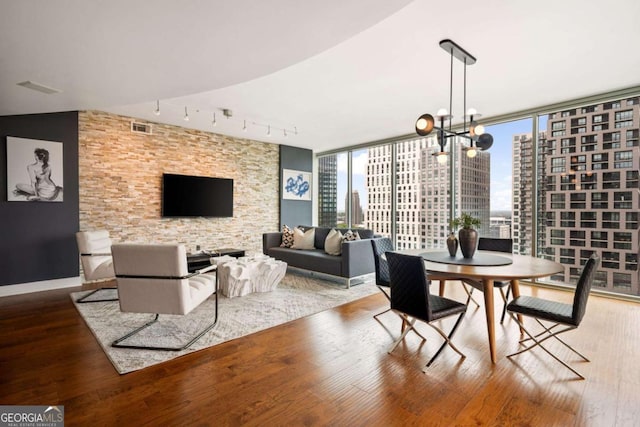 20 10th St NW Unit 2003, Atlanta, GA 30309 - dining area featuring wood finished floors, a chandelier, and rail lighting