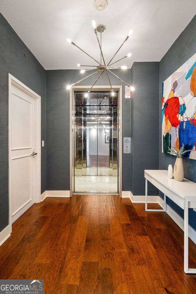 20 10th St NW Unit 2003, Atlanta, GA 30309 - dining space featuring a chandelier, wood finished floors, baseboards, and elevator