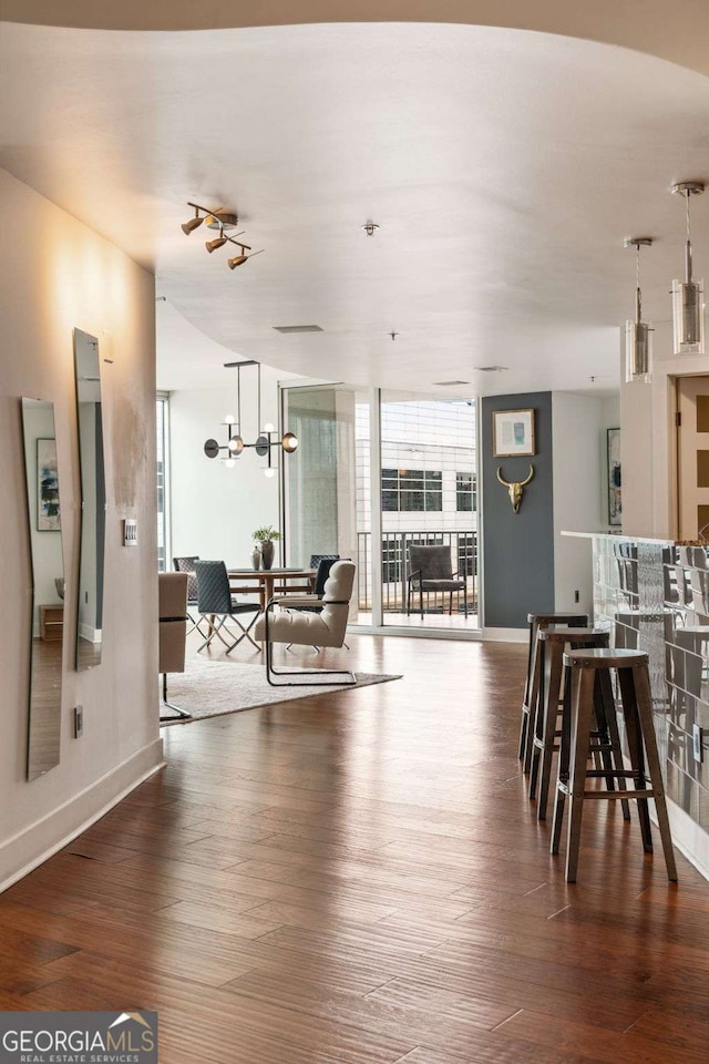 20 10th St NW Unit 2003, Atlanta, GA 30309 - living area with wood finished floors, baseboards, and a wall of windows