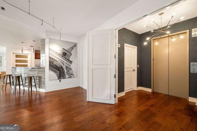 20 10th St NW Unit 2003, Atlanta, GA 30309 - dining area with a chandelier, wood finished floors, and baseboards