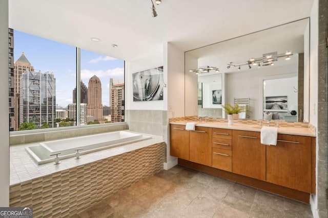 20 10th St NW Unit 2003, Atlanta, GA 30309 - bathroom featuring a bath, vanity, and a view of skyline