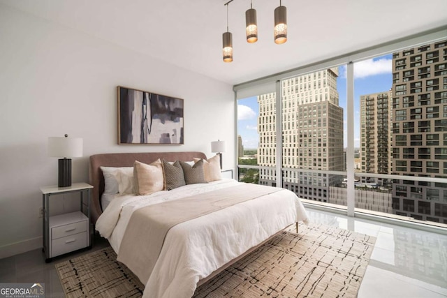 20 10th St NW Unit 2003, Atlanta, GA 30309 - tiled bedroom with multiple windows, a view of city, floor to ceiling windows, and baseboards