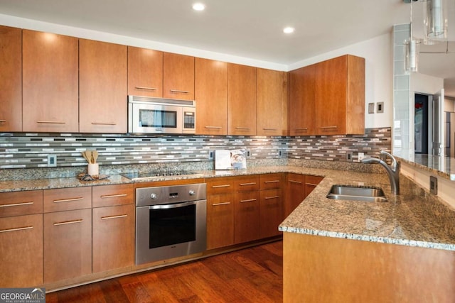 20 10th St NW Unit 2003, Atlanta, GA 30309 - kitchen with appliances with stainless steel finishes, a sink, brown cabinets, dark wood-style floors, and light stone countertops