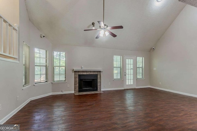 1074 Cherokee Hts, Stone Mountain, GA 30083 - unfurnished living room featuring lofted ceiling, a ceiling fan, dark wood-style flooring, and a tile fireplace