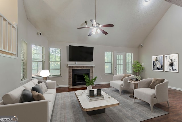 1074 Cherokee Hts, Stone Mountain, GA 30083 - living room featuring dark wood-style flooring, plenty of natural light, a ceiling fan, high vaulted ceiling, and a fireplace
