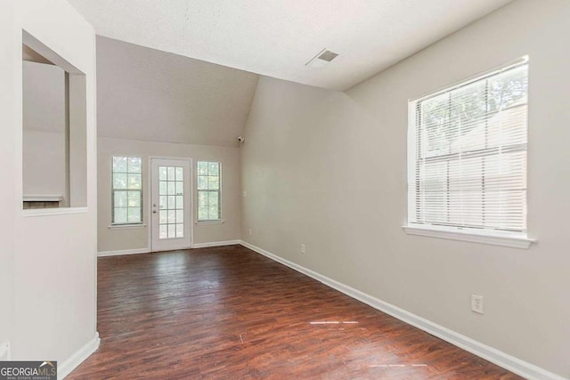 1074 Cherokee Hts, Stone Mountain, GA 30083 - spare room featuring healthy amount of natural light, dark wood finished floors, and vaulted ceiling