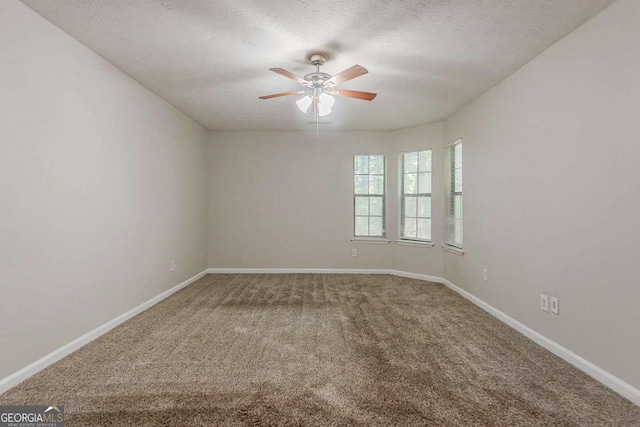 1074 Cherokee Hts, Stone Mountain, GA 30083 - unfurnished room featuring ceiling fan, carpet flooring, and a textured ceiling